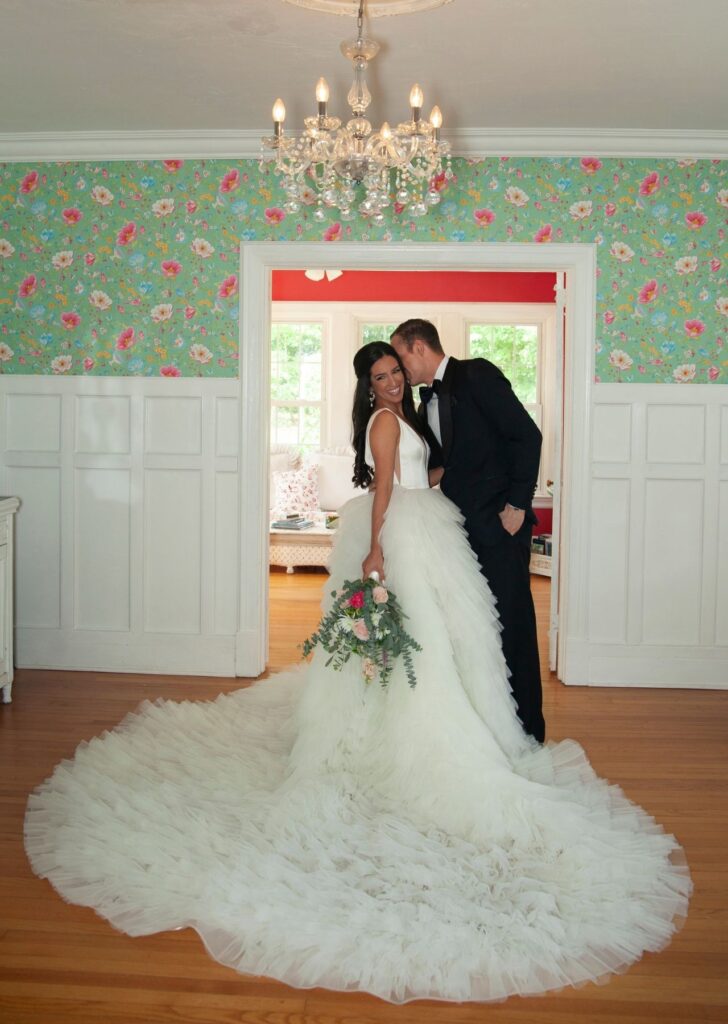 Bride and groom posing for a photo inside manor at garden wedding venue