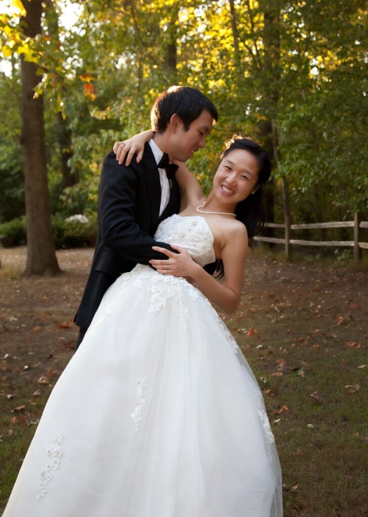 Groom dipping bride to pose for a photo at garden wedding venue