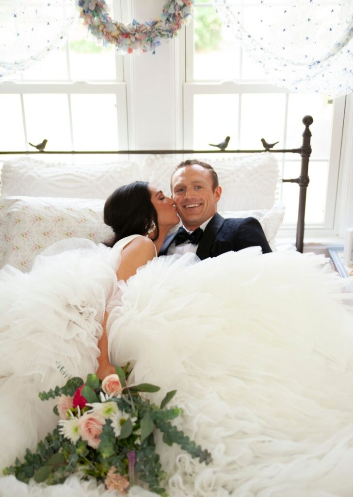 Bride kissing groom in bridal suite after wedding