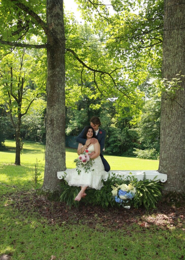 Wedding photos of couple on swing embracing each other