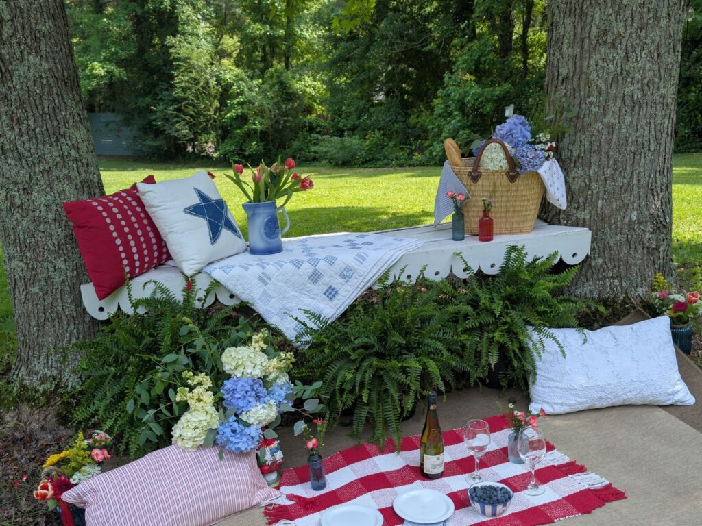 Photo background with bench, plants, pillows, and more at garden wedding venue