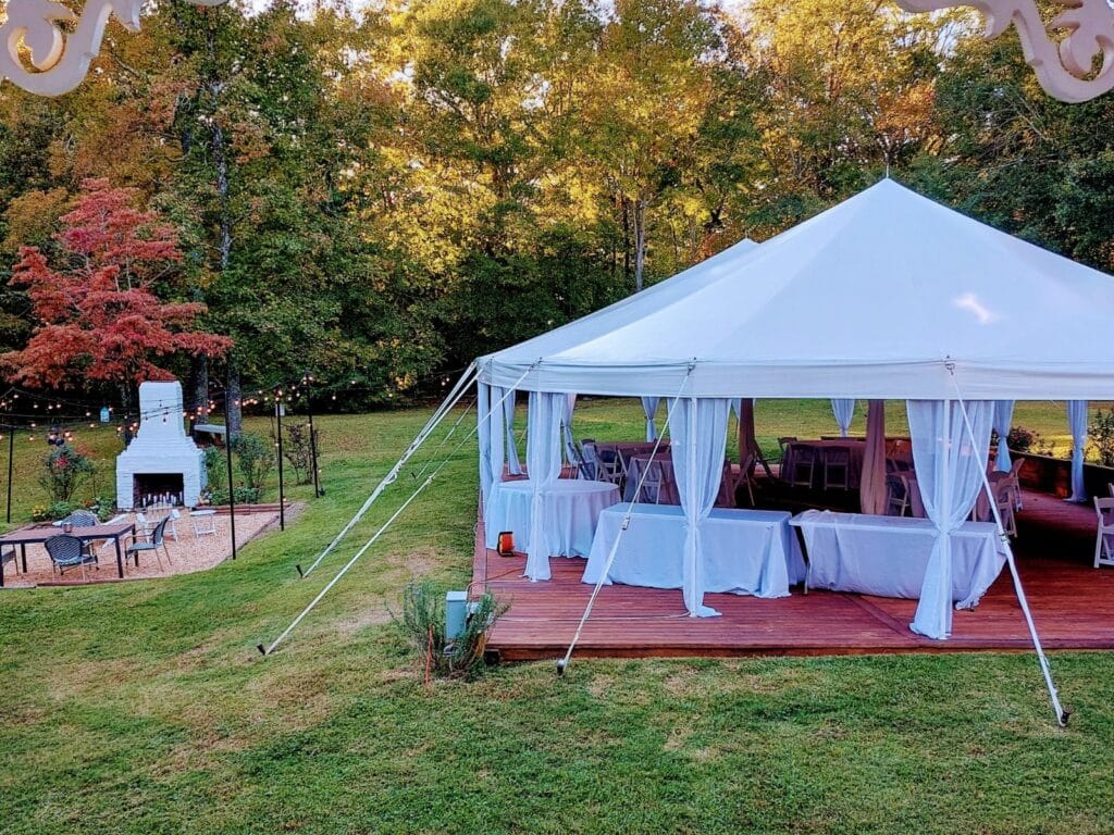 Tent and fire place outside at garden wedding venue