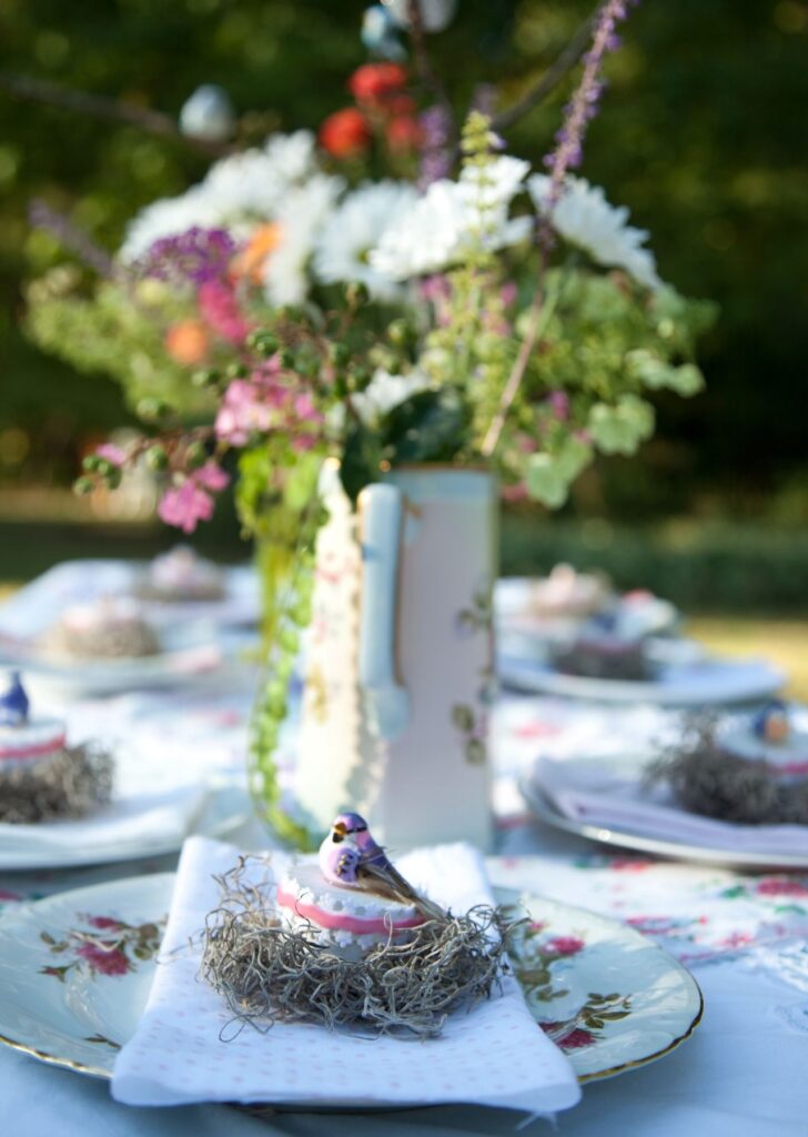 Bird decorations on table at garden wedding venue