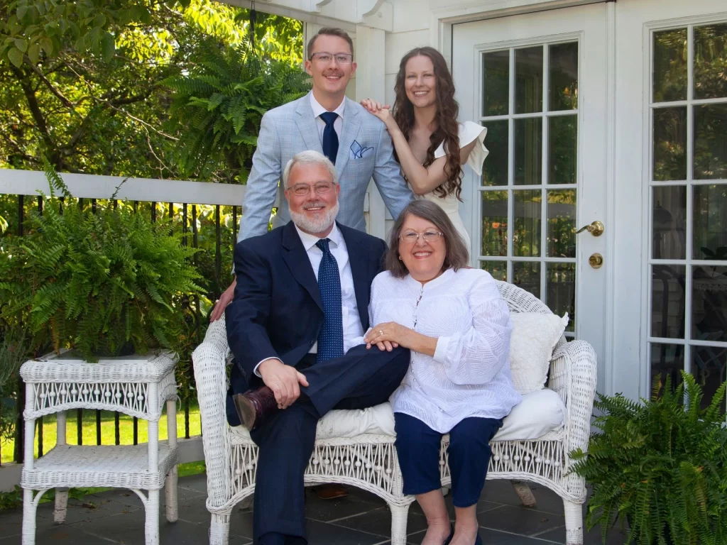 Family sitting on bench outside corporate event venue in North Carolina